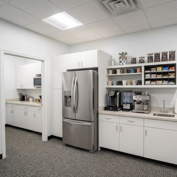 Kitchen area with fridge and coffee station